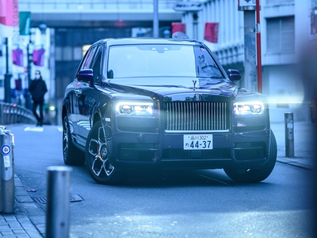 Автомобиль Rolls-Royce Cullinan с включенными фарами