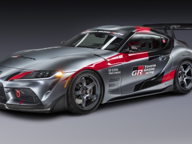 Автомобиль Toyota GR Supra,  2020 года на сером фоне 