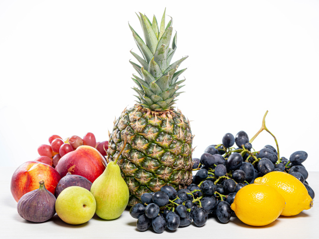 Ананас, виноград, инжир, лимон, нектарин и груши на белом фоне
