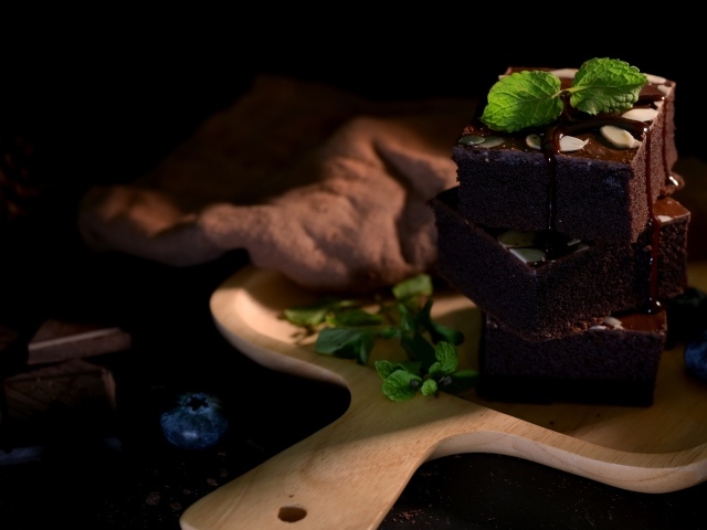 Шоколадный десерт брауни на доске с ягодам черники 