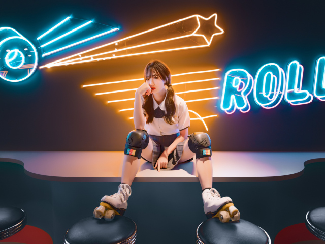 Девушка азиатка сидит в роликах на фоне вывески 