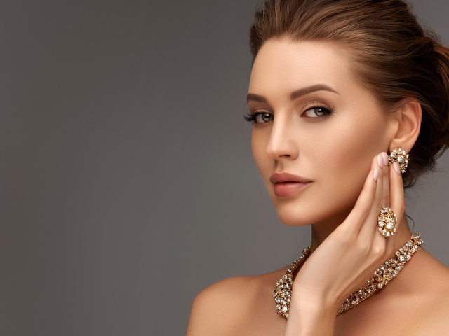 Красивая девушка с вечерней прической и дорогими украшениями