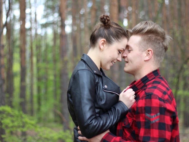 Влюбленная пара стоит в лесу 