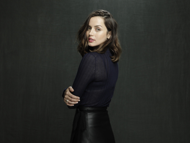 Актриса Ана де Армас в черной юбке на сером фоне