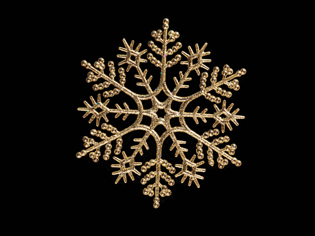 Красивая золотистая снежинка на черном фоне