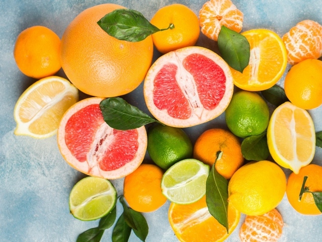 Аппетитные цитрусовые фрукты с зелеными листьями