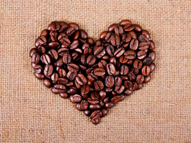 Сердце из обжаренных кофейных зерен на мешковине
