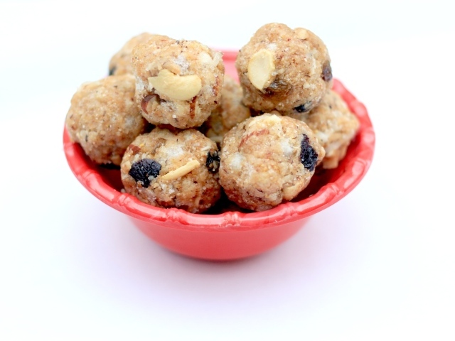 Десерт ладду в красной миске на сером фоне