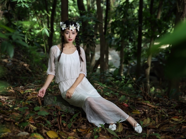 Красивая девушка азиатка в белом платье  в лесу