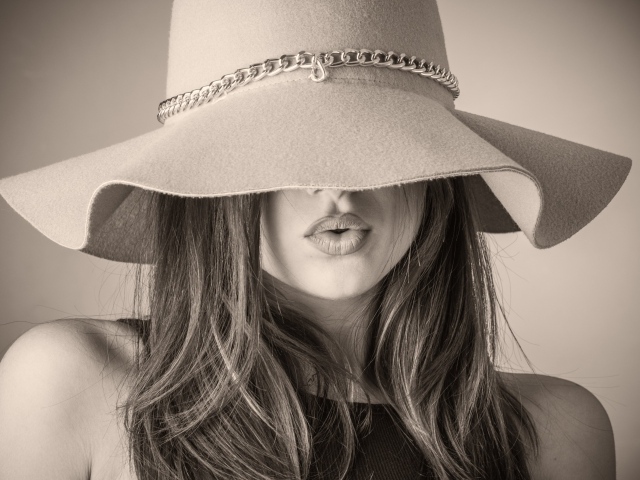 Красивая девушка закрыла лицо шляпой 