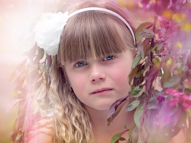 Грустная маленькая девочка у ветки дерева 