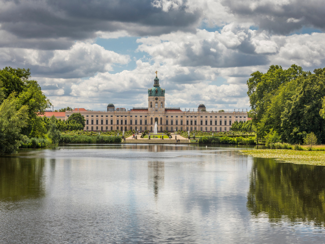 Красивый вид на замок Шарлоттенбург у озера под белыми облаками