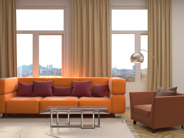 Большой оранжевый диван с подушками у окна 