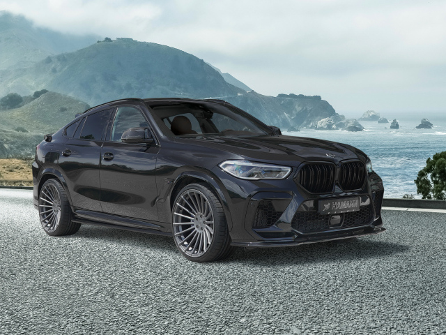 Черный автомобиль Hamann BMW X6 M Competition 2021 года на фоне гор