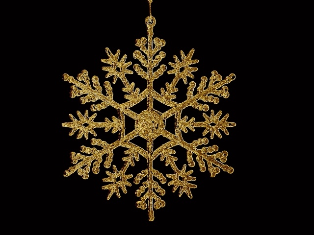 Золотая снежинка на черном фоне 