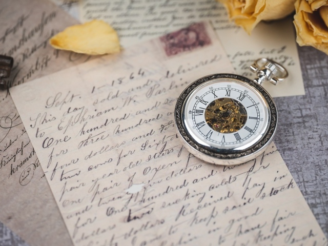 Карманные часы с письмом на столе