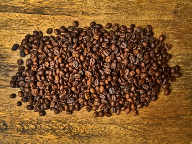 Жареные кофейные зерна на деревянном столе