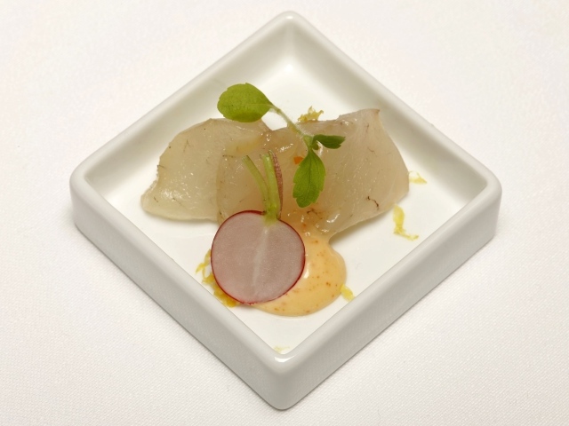 Кусочки сырой рыбы в тарелке с редисом