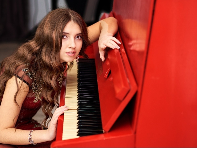 Девушка музыкант с красным пианино