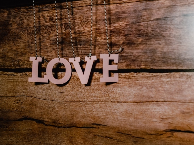 Буквы с надписью Любовь на деревянном фоне