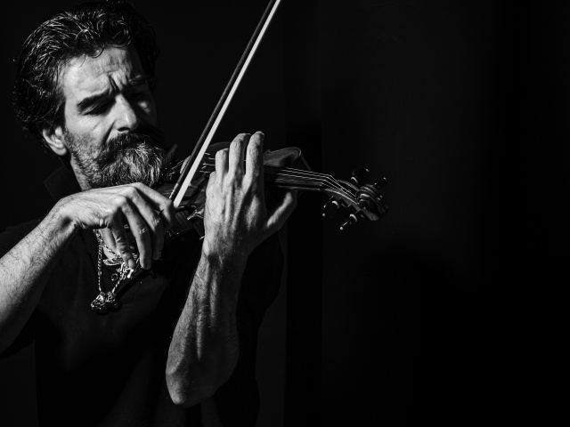 Мужчина музыкант со скрипкой в руках