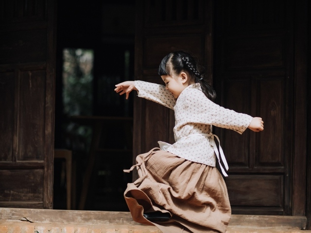 Маленькая девочка азиатка танцует