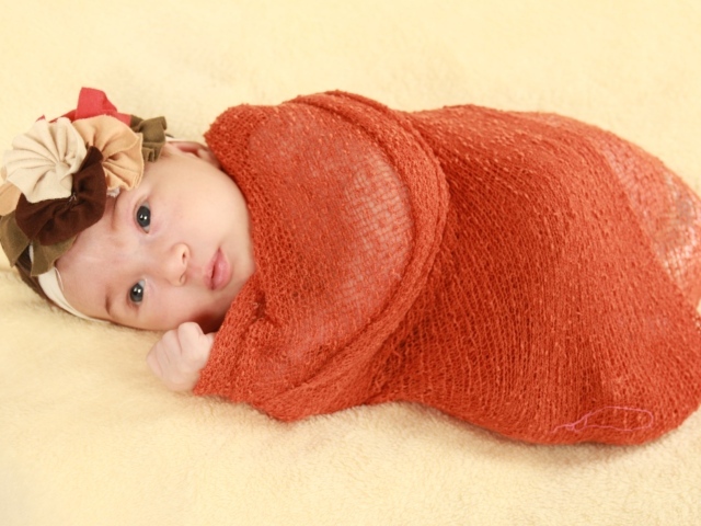 Новорожденная девочка в красном покрывале