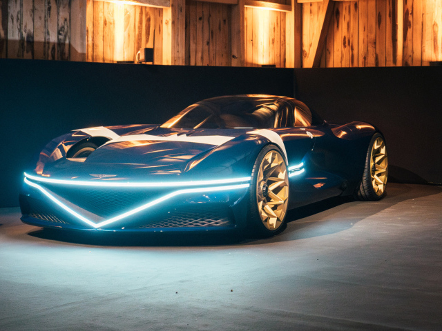 Автомобиль Genesis X Gran Berlinetta Tribute 2024 года с включенными фарами