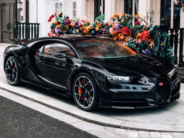 Черный автомобиль Bugatti Chiron у здания