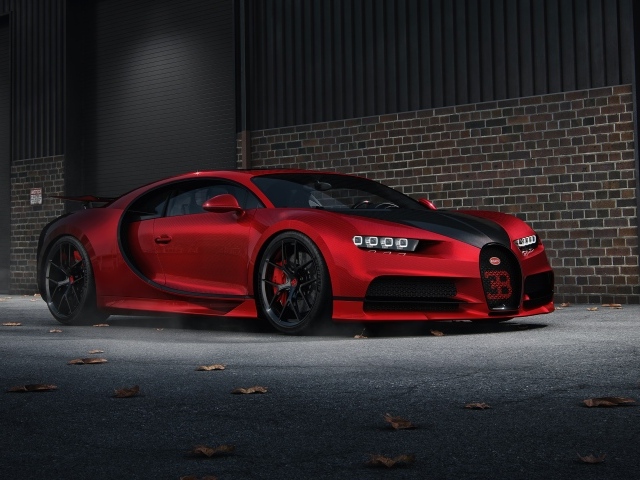 Красный автомобиль Bugatti Chiron CGI у кирпичной стены