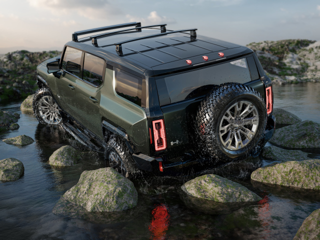 Внедорожник GMC Hummer EV Pickup 2024 года едет по камням