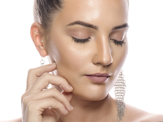 Девушка с закрытым глазами на белом фоне