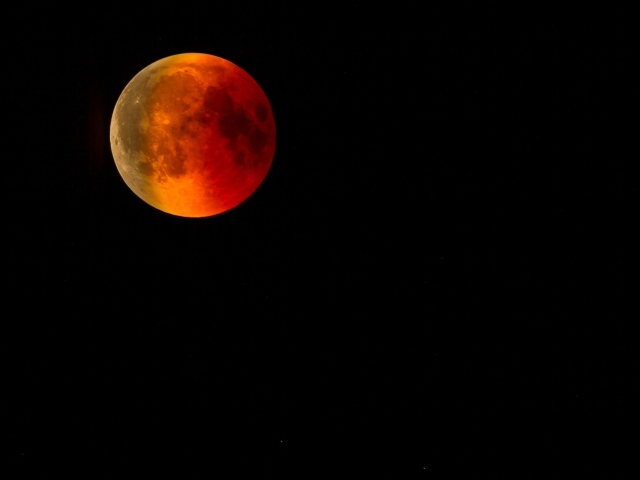 Большая красная луна на черном фоне