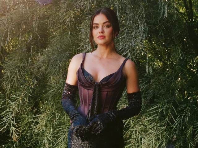 Актриса Люси Хейл в черном платье у зеленых зарослей
