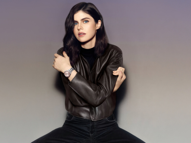 Актриса Александра Даддарио в черной куртке на сером фоне