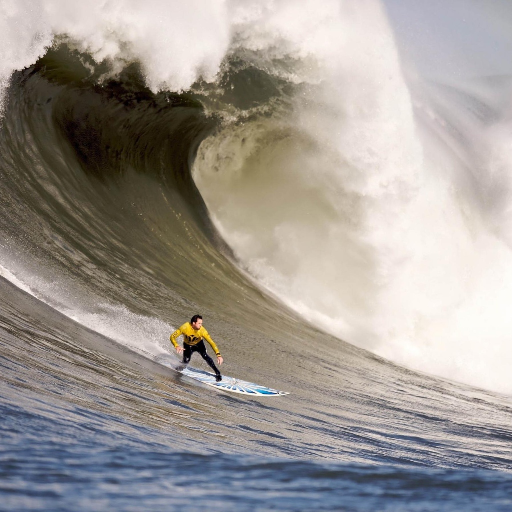 Серфер спускается с волны