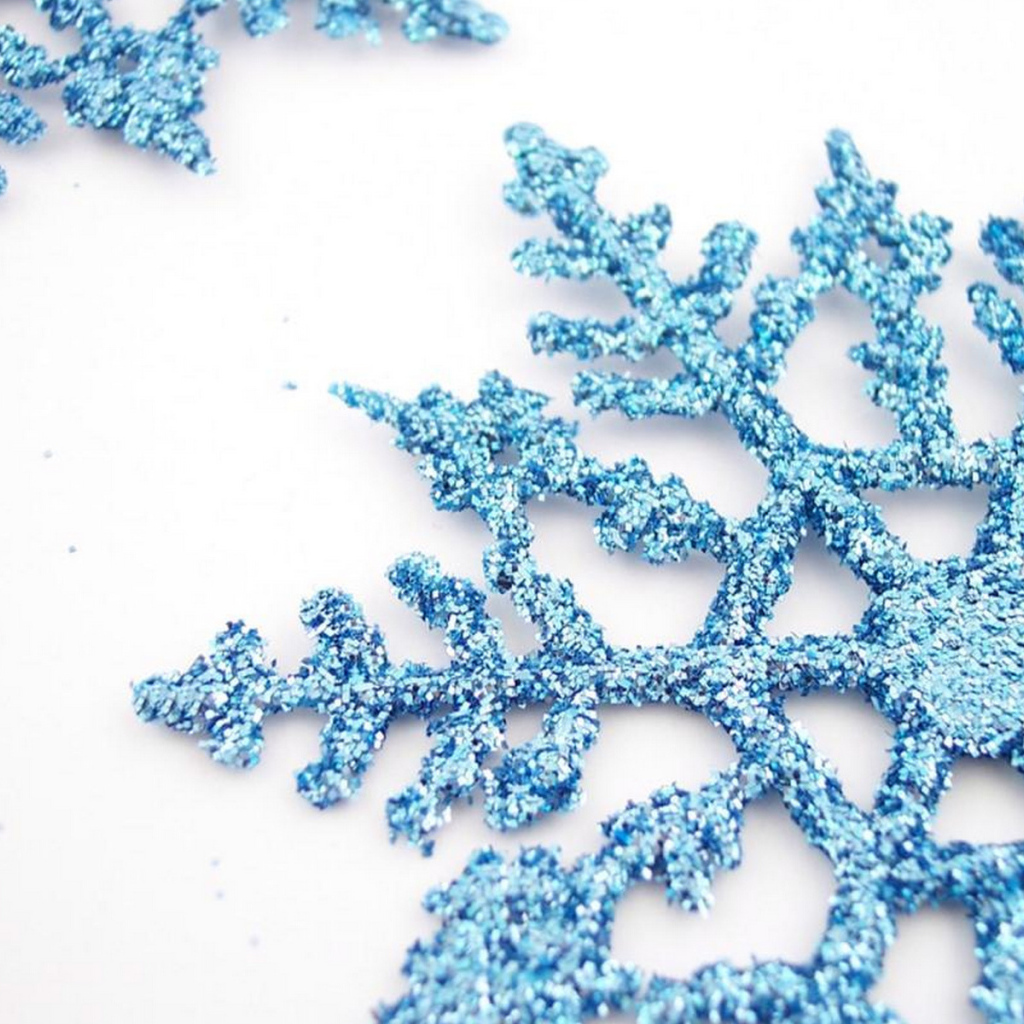Blue snowflakes on a white table on Christmas