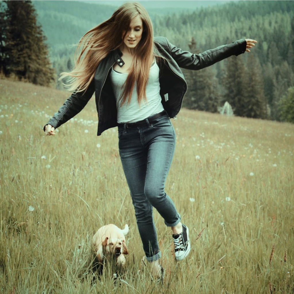 Девушка с собачкой бежит по полю