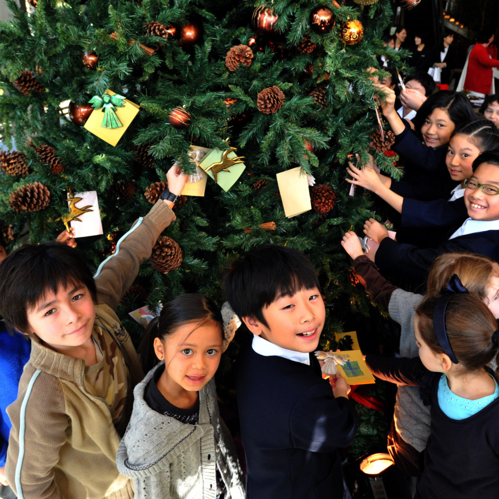 Дети рядом с новогодней елкой