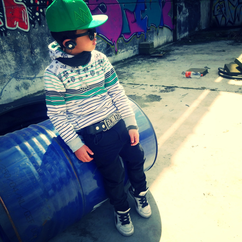 A boy in a green cap and barrel, swag