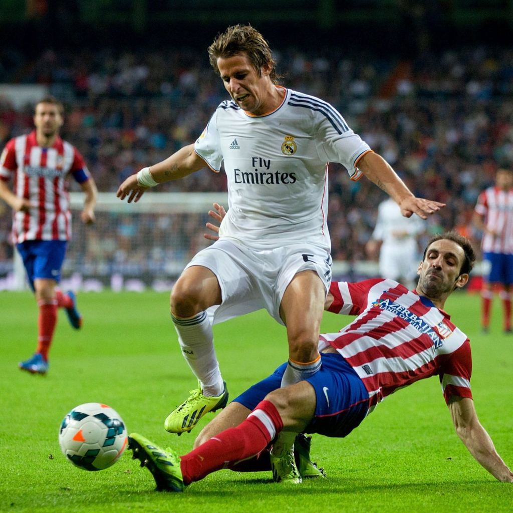 The football player of Real Madrid Fábio Coentrão is fighting for the ball