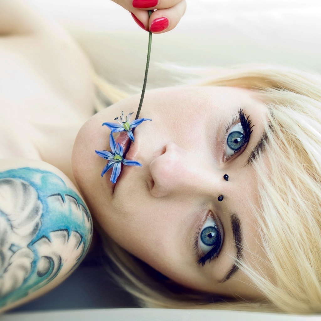 The girl with blue eyes and a beautiful tattoo