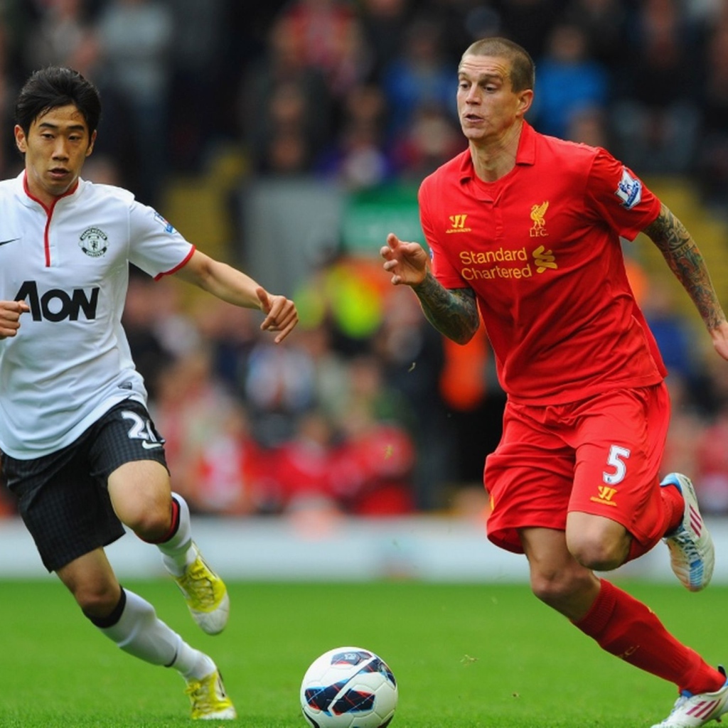 The player of Liverpool Daniel Agger is running forwards to the ball