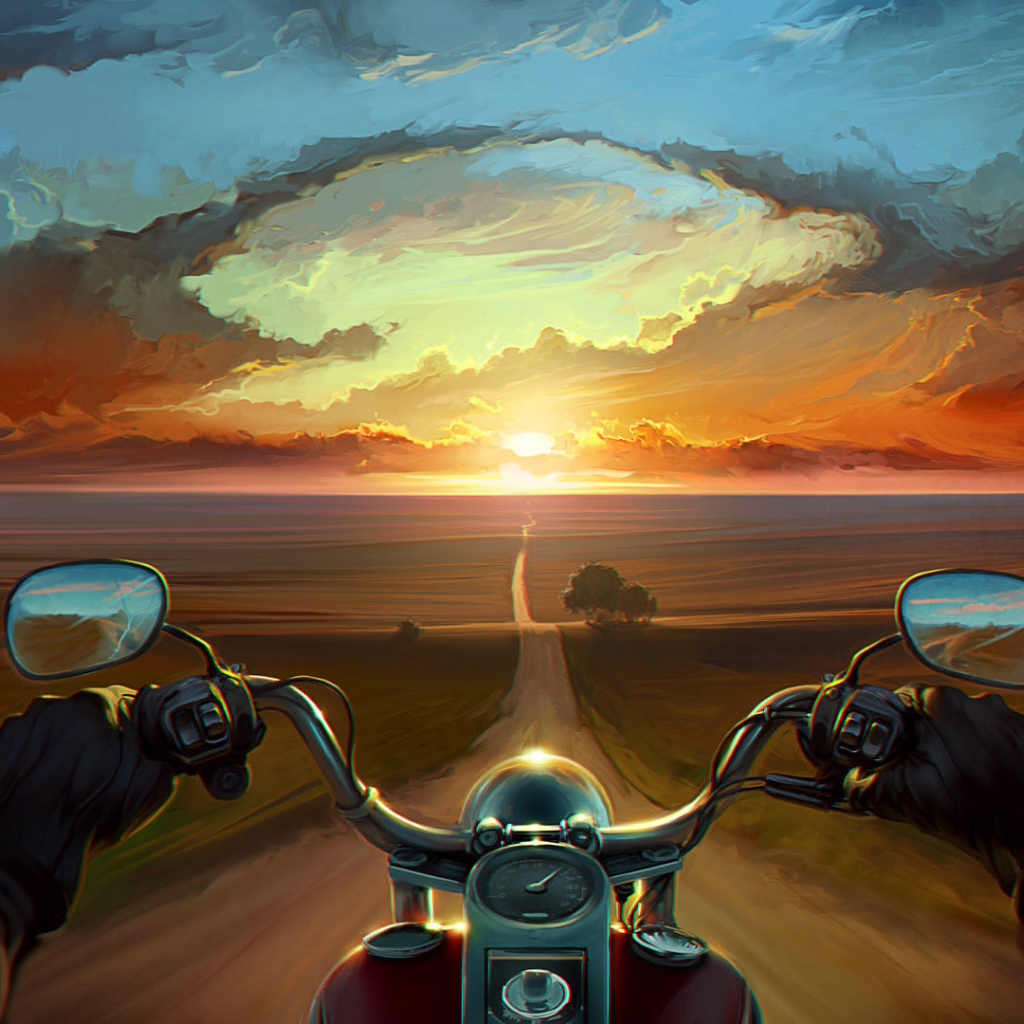 Мотоциклист едет на закат
