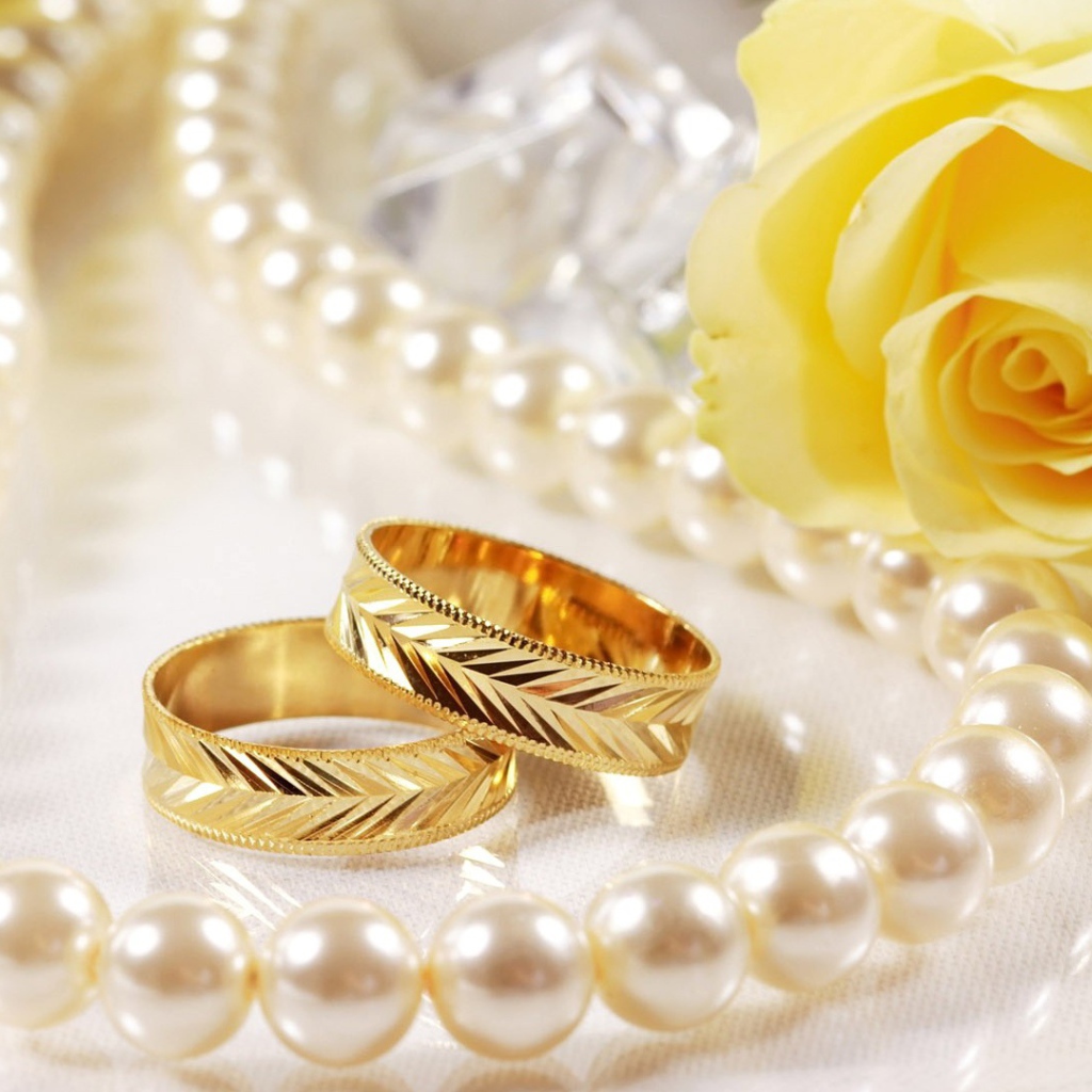Wedding rings and yellow rose