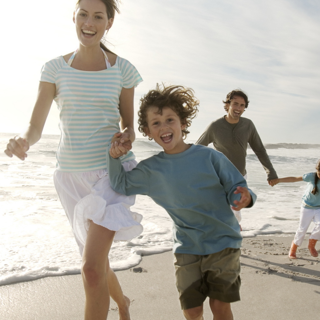 Семья гуляет на пляже