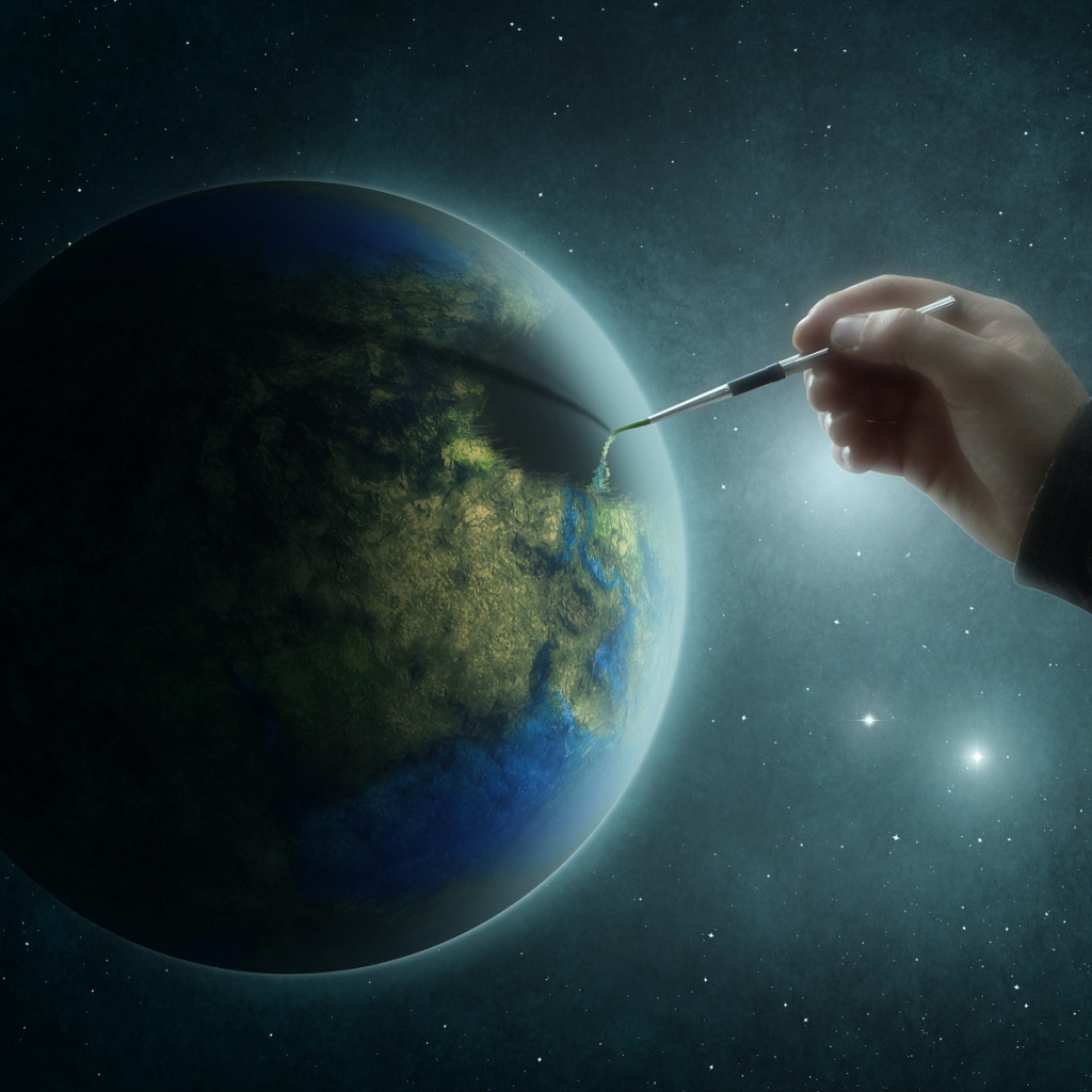 Рука рисует на планете