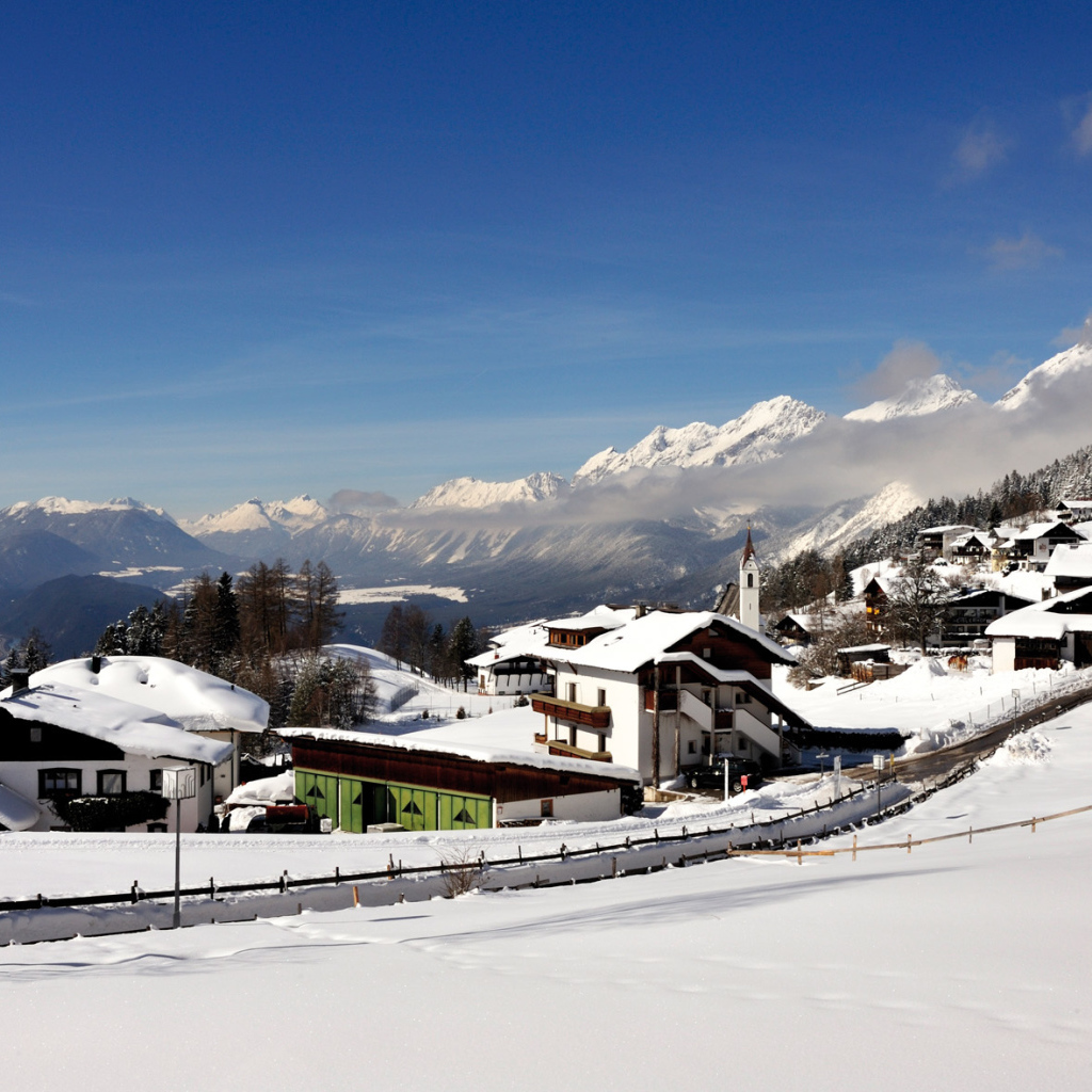 Дома на фоне гор на курорте Зеефельд, Австрия