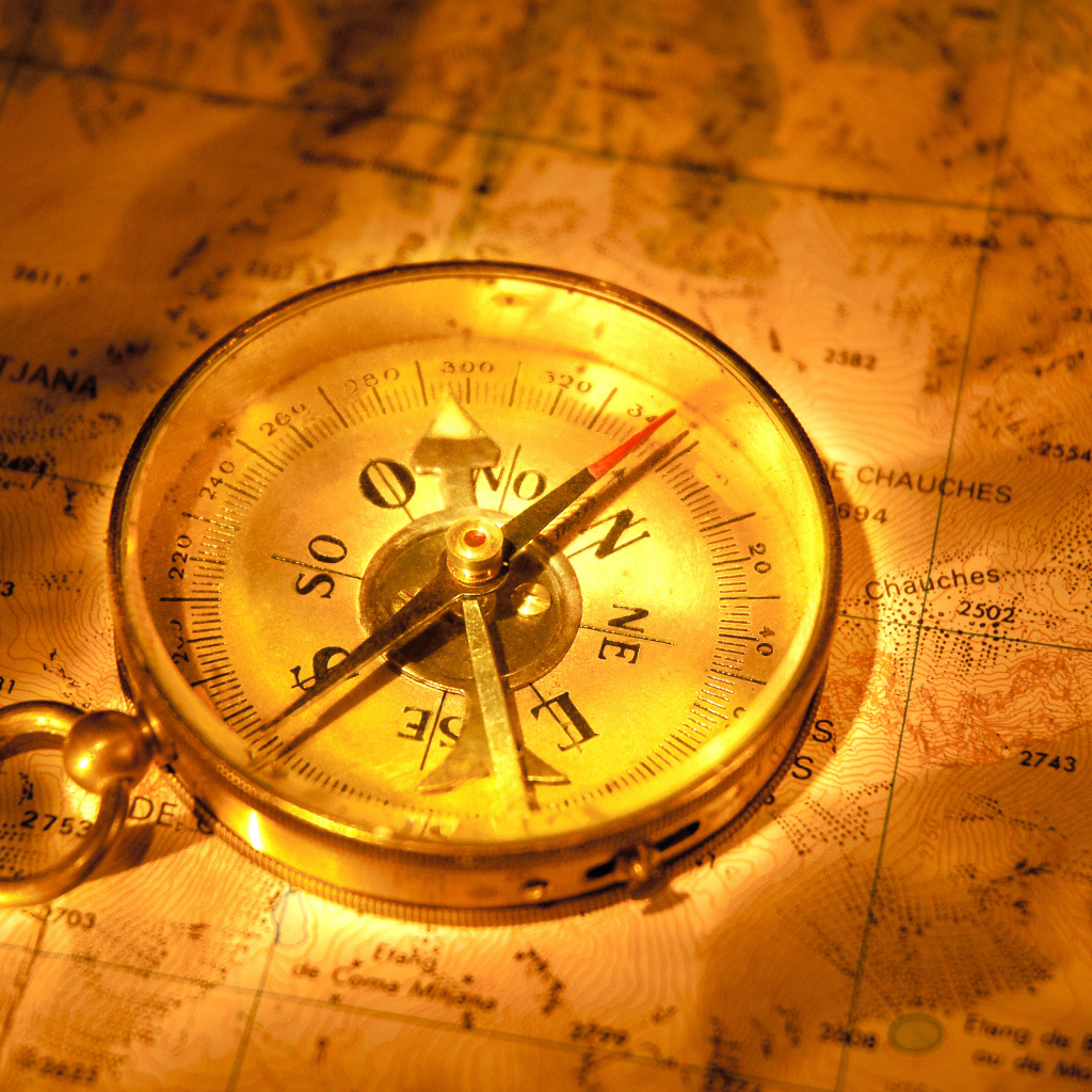 Старинный компас на карте путешественника