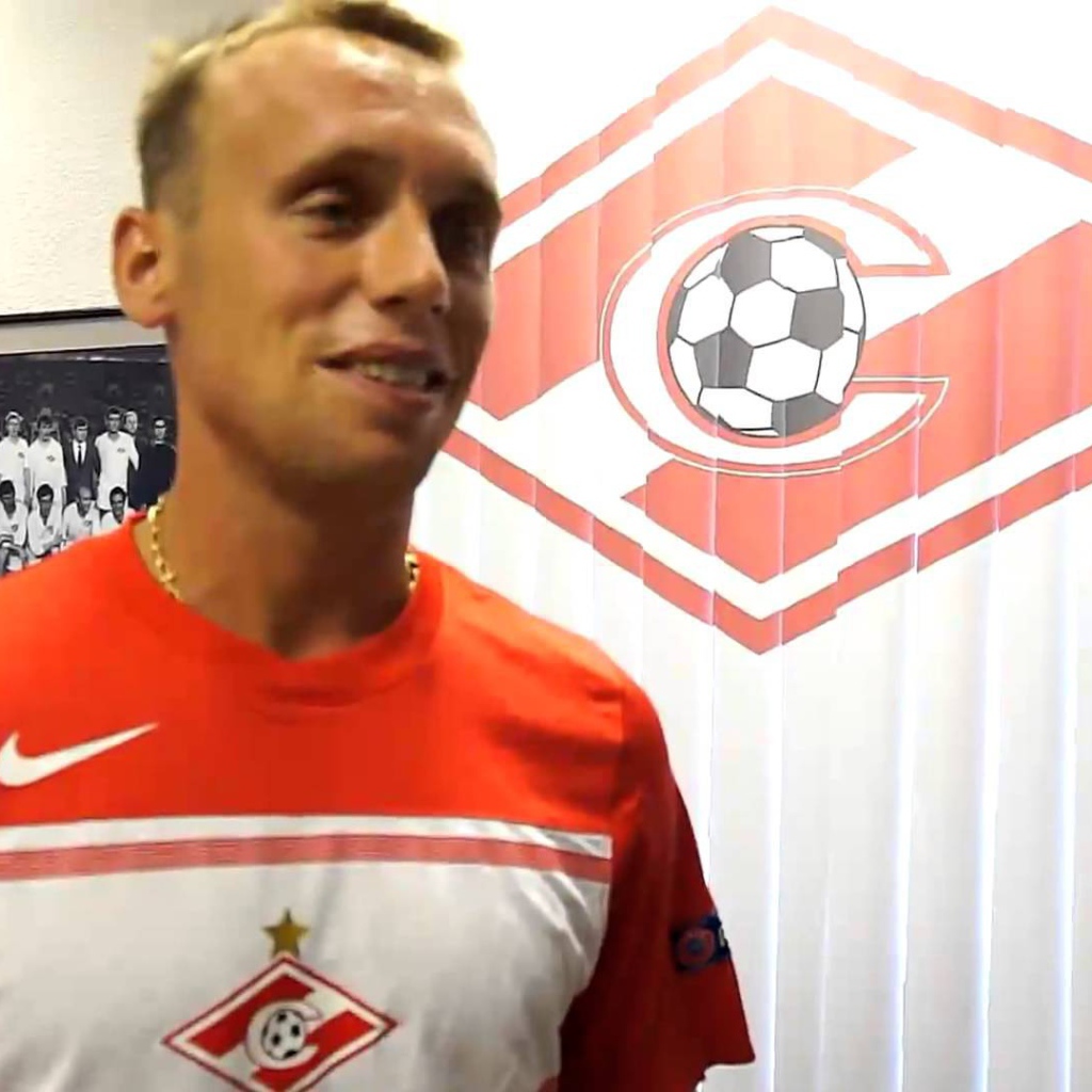 Денис Глушаков полузащитник Спартака на фоне логотипа команды